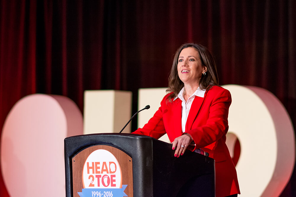 A woman speaks to the audience at the 2016 Head 2 Toe Conference