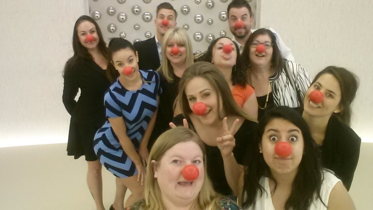 Group of people wearing red noses for Red Nose Day