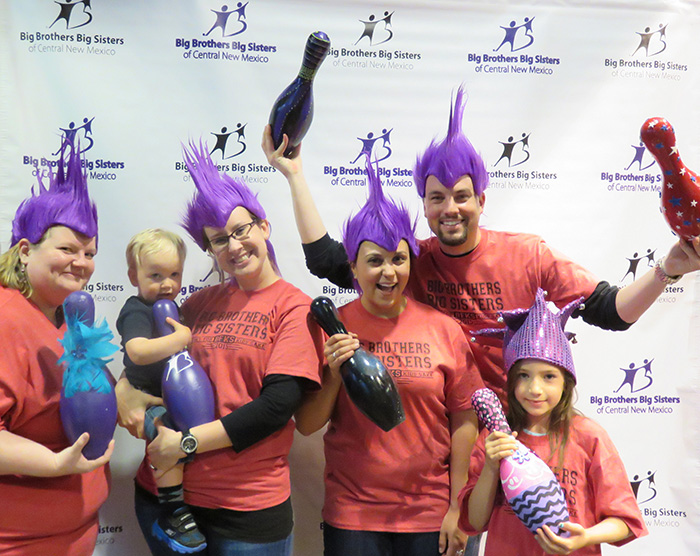Big Brothers and Big Sisters give back to the community, wearing purple hair