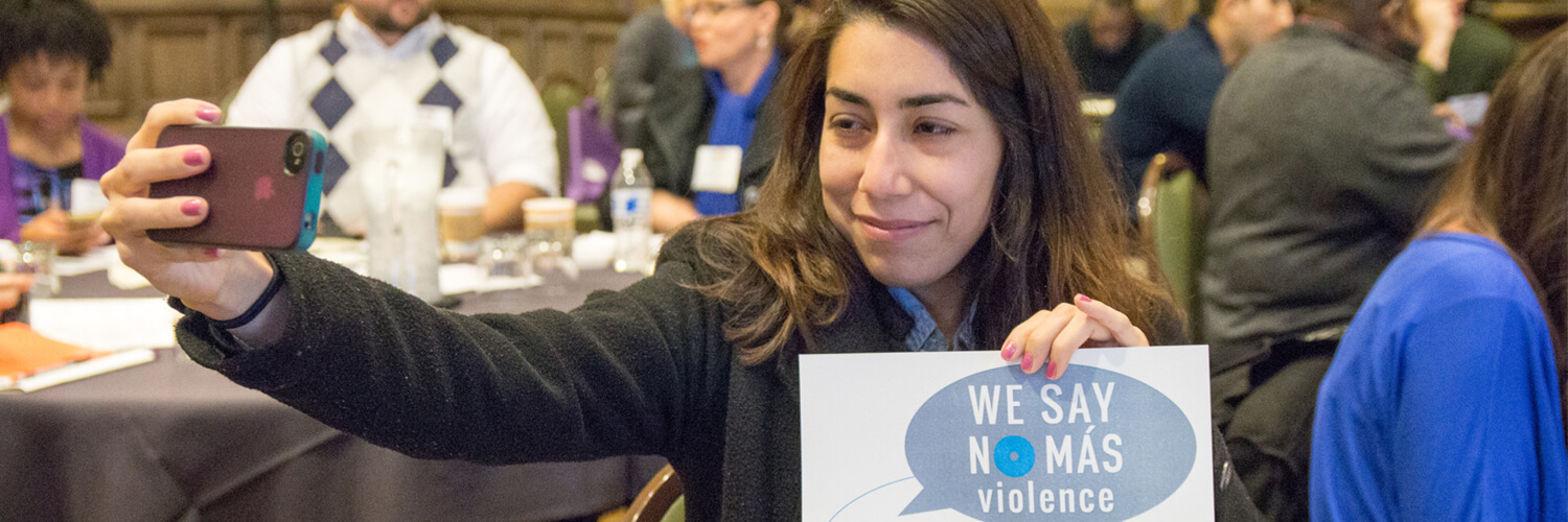 Woman takes a selfie at the We Say No Mas violence conference