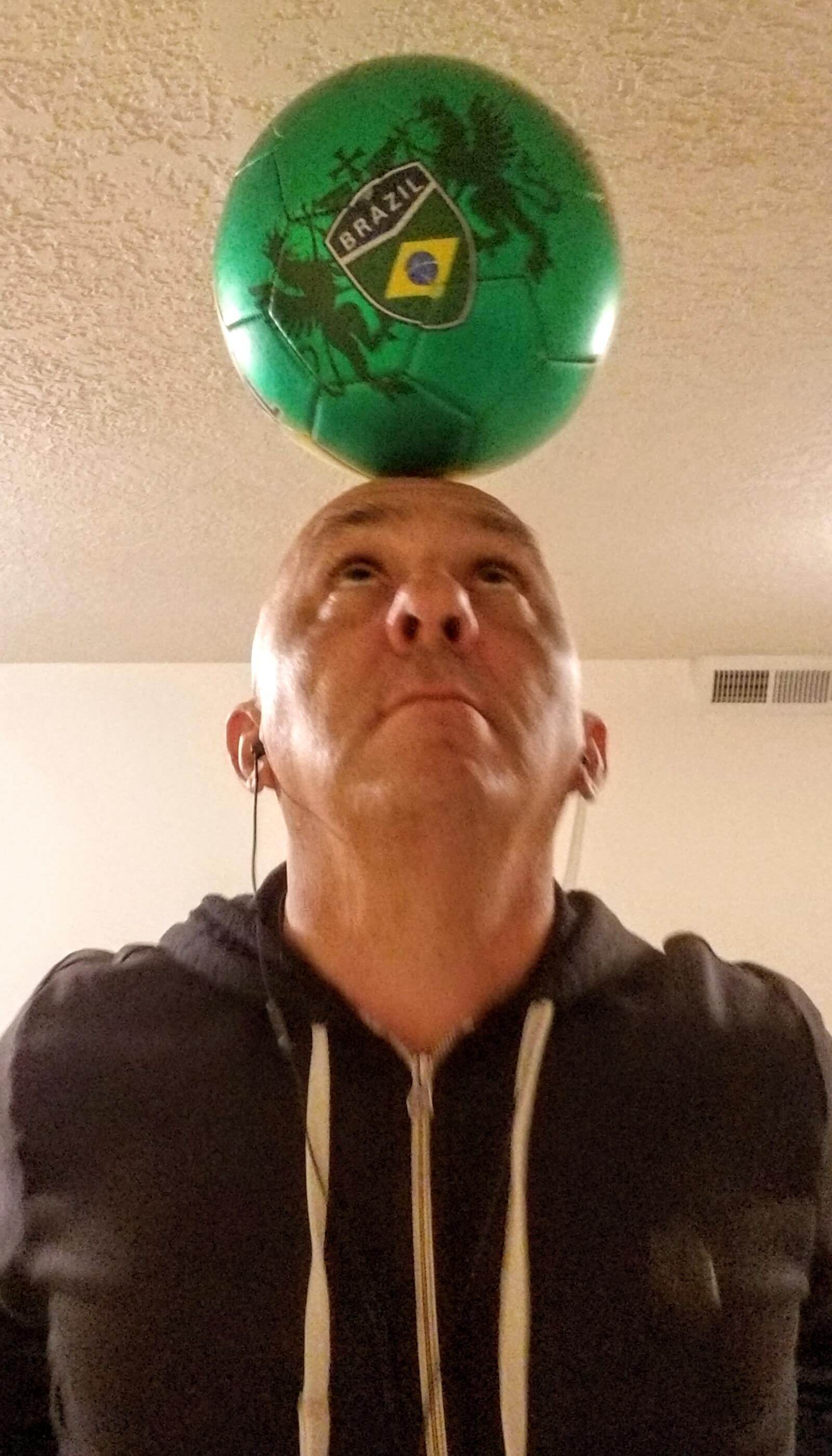 Man with a soccer ball on his head